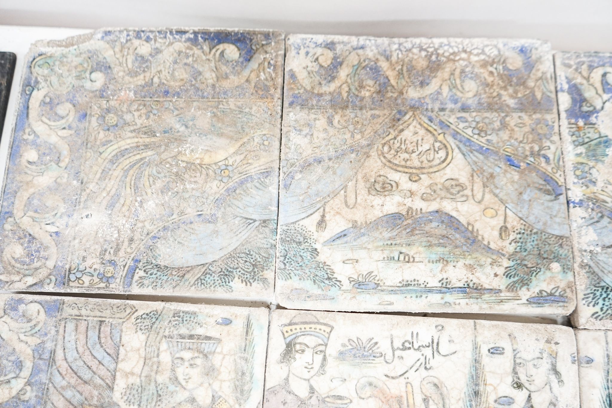 A Persian fritware tile panel, late 19th/early 20th century, incomplete, 55cm wide and another tile fragment
